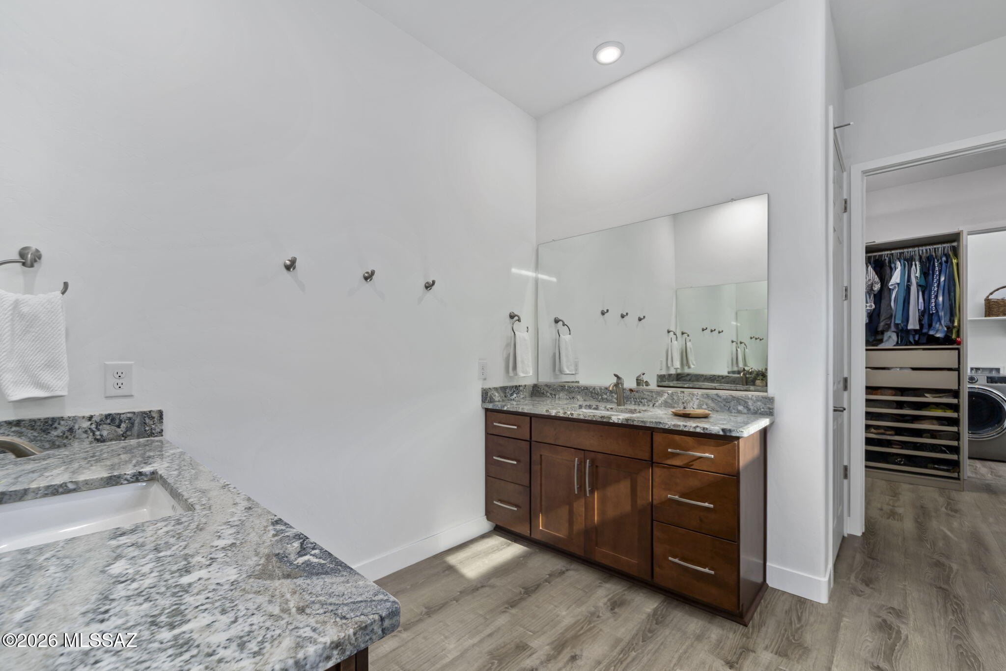 12791 East Tortoise Pointe Drive Vail, AZ 85641 - Photo 26 of 50 a spacious bathroom with a granite countertop sink and a mirror