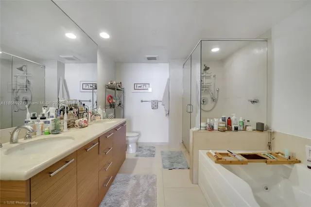 a bedroom with a large bed and a view of kitchen