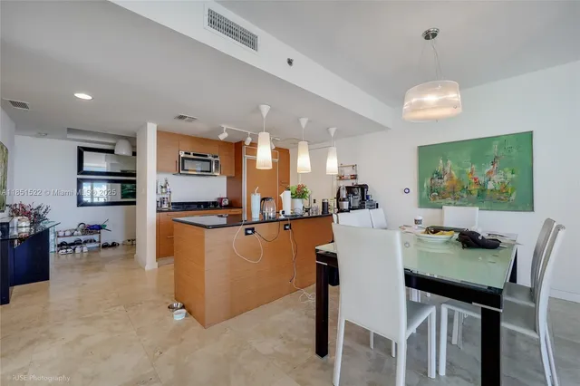 a kitchen with stainless steel appliances a sink stove and cabinets