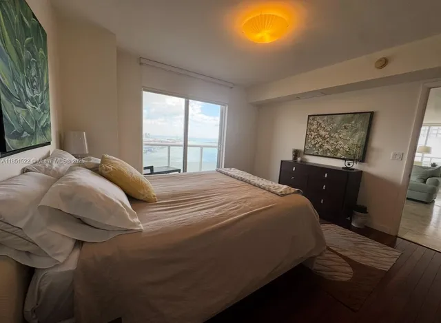 a spacious bathroom with a granite countertop sink toilet mirror and bathtub