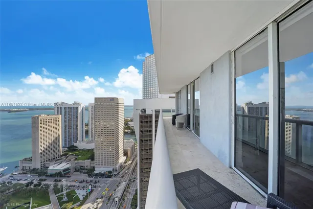a view of a hallway with a living room filled with furniture