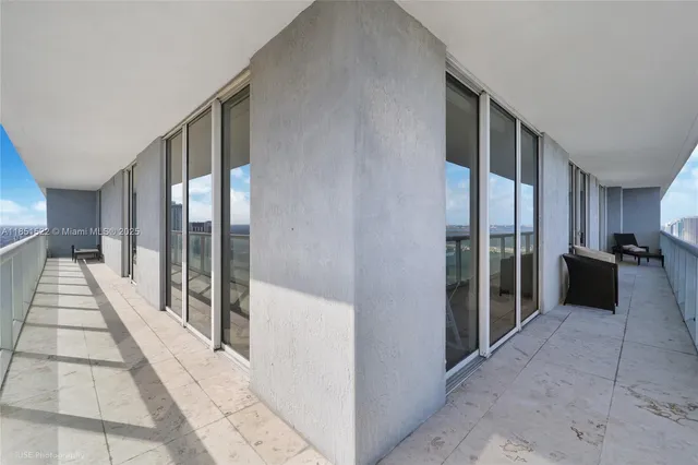 a living room with furniture and a large window with garden view