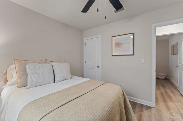 a bedroom with a bed and a ceiling fan
