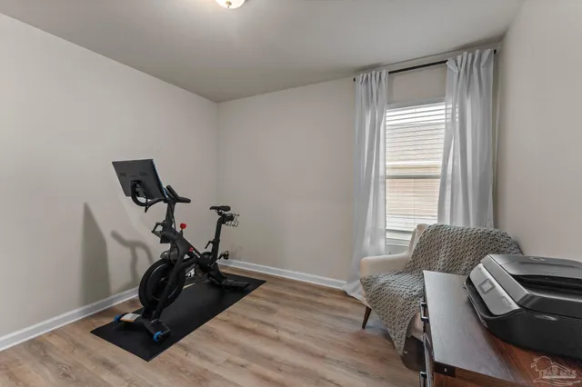 a room with gym equipment and a window