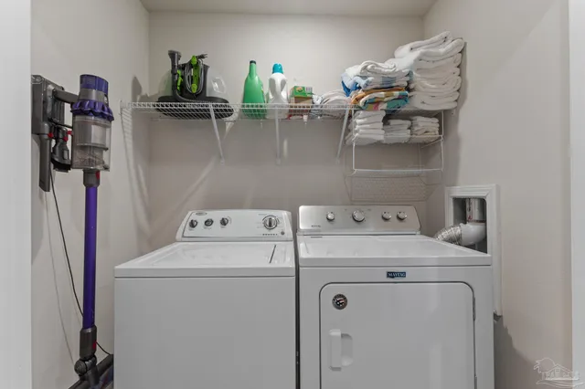 a view of storage and utility room with washer and dryer