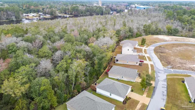 an aerial view of a house with a yard and lake view