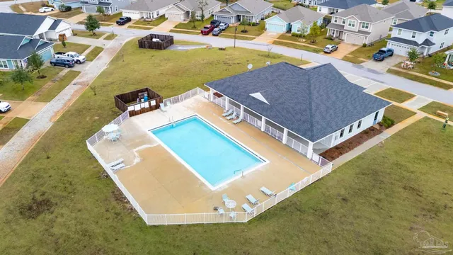 an aerial view of a house with a swimming pool