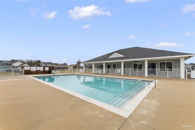 a view of a house with pool and a yard