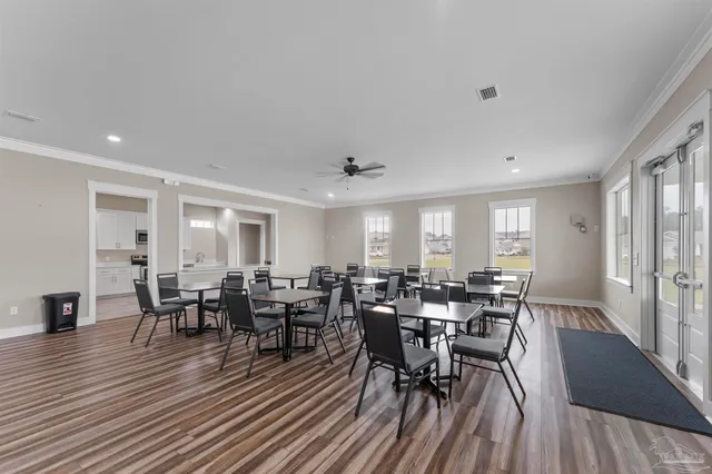 a view of a dining room with furniture and wooden floor