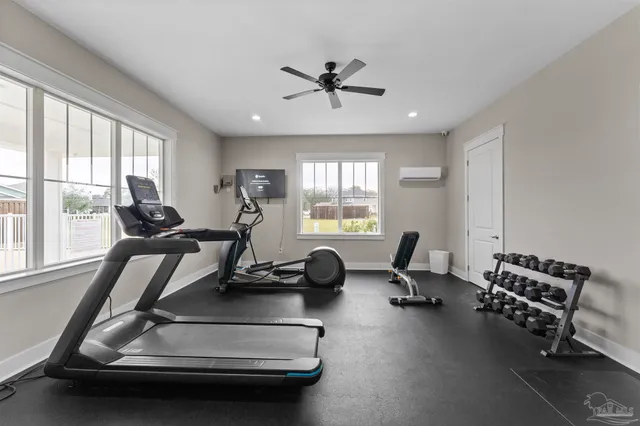 a room with gym equipment and windows