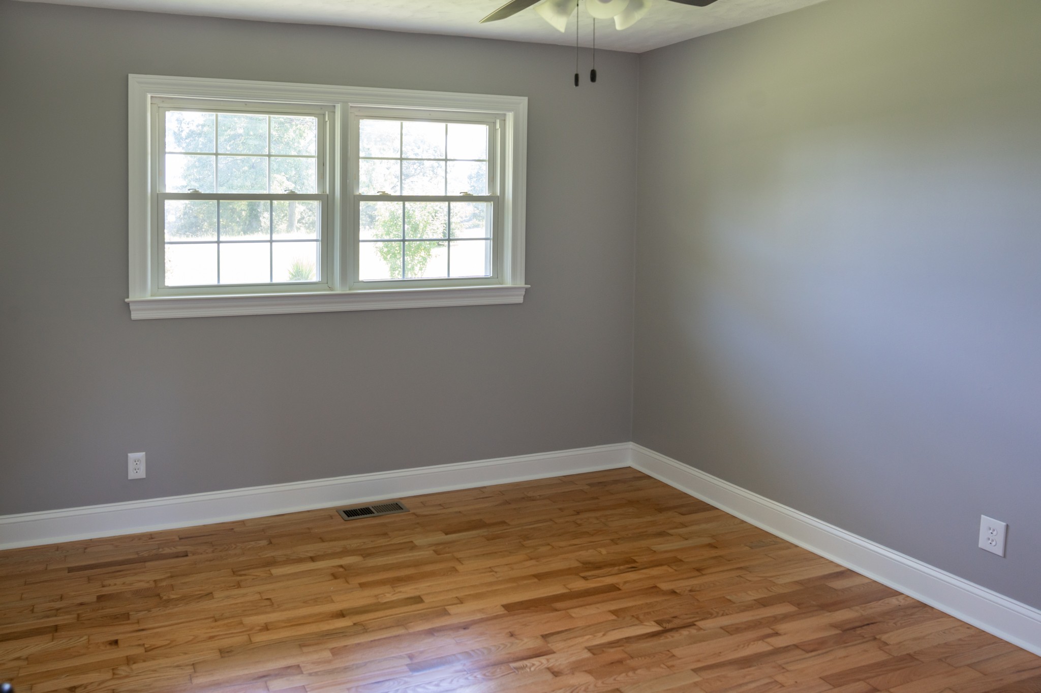 239 Durham Road Leoma, TN 38468 - Photo 7 of 10 an empty room with wooden floor and windows