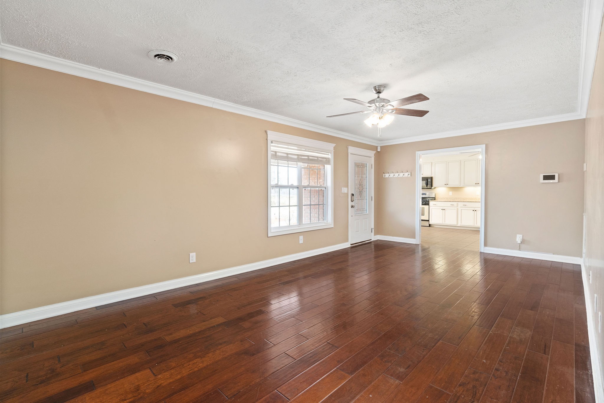 140 Batson Road Cunningham, TN 37052 - Photo 5 of 18 a view of an empty room with window and wooden floor