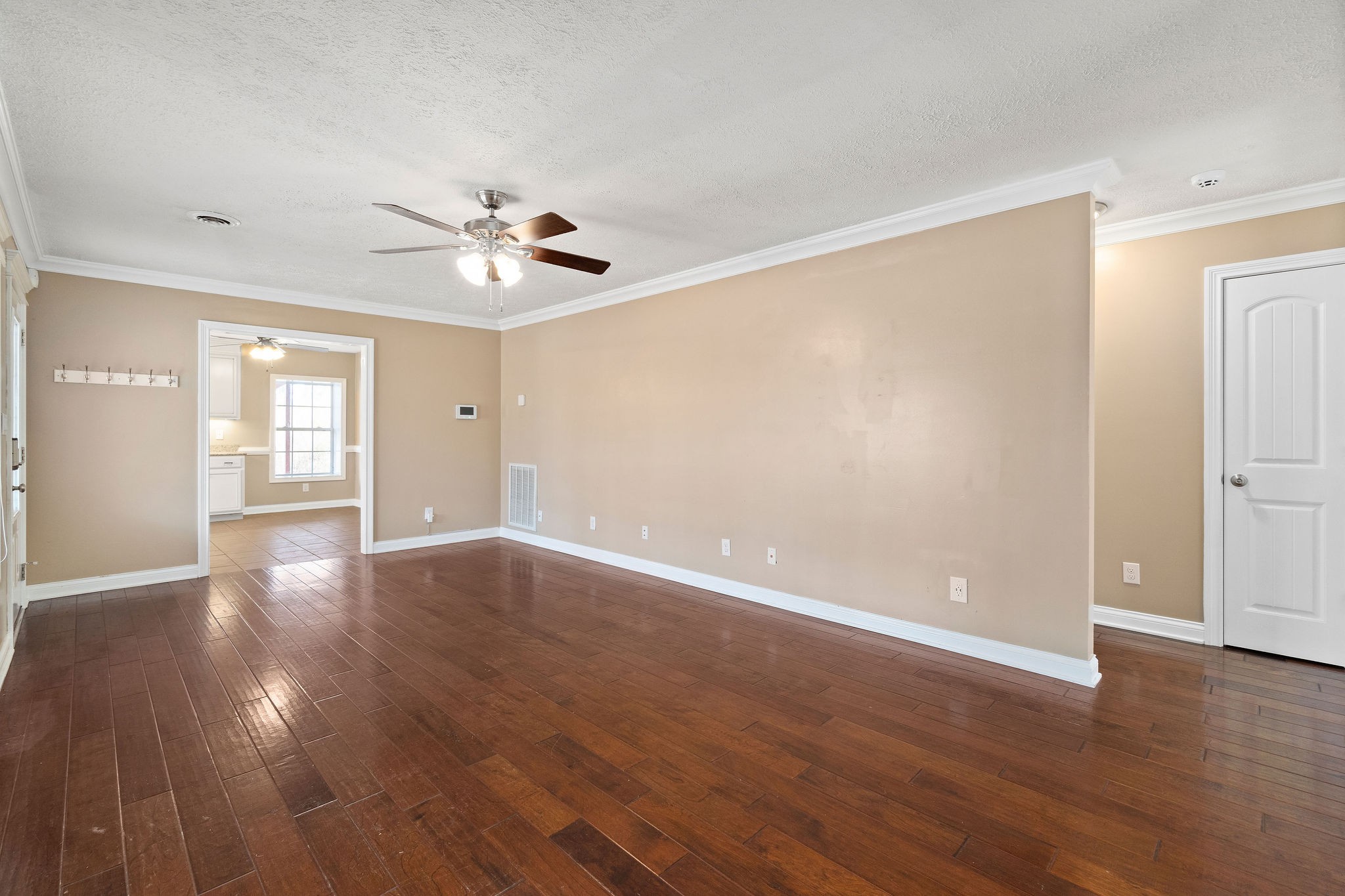 140 Batson Road Cunningham, TN 37052 - Photo 6 of 18 a view of an empty room with wooden floor and a ceiling fan