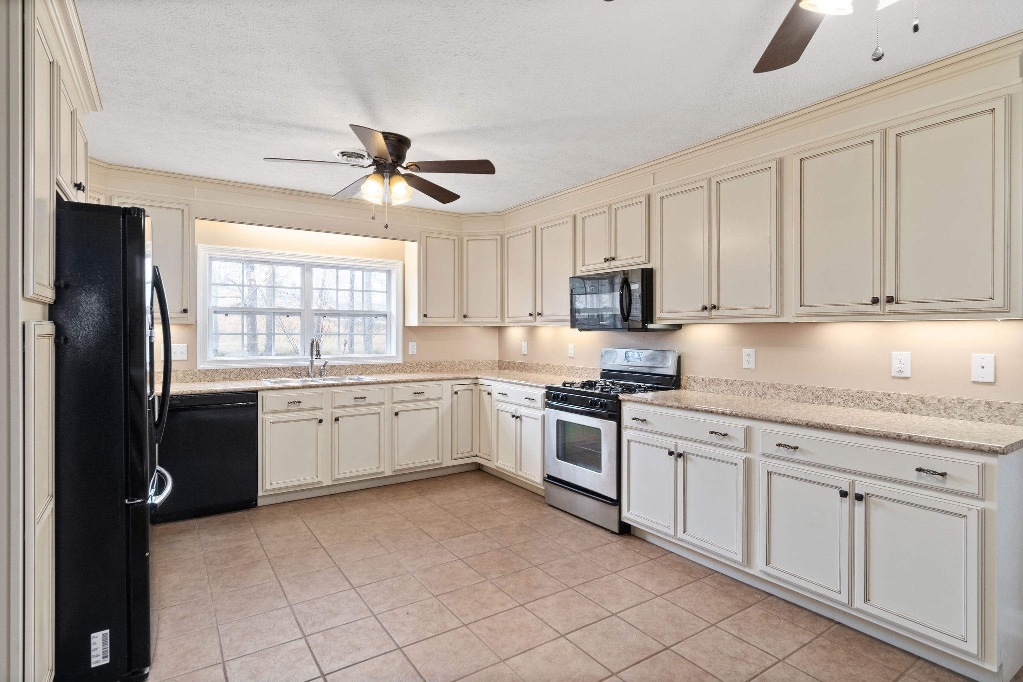 140 Batson Road Cunningham, TN 37052 - Photo 7 of 18 a kitchen with granite countertop white cabinets and white appliances