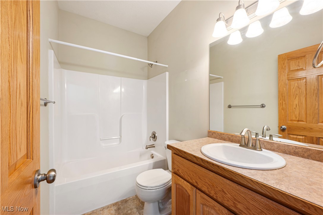 706 Watson Road Deerfield, OH 44411 - Photo 20 of 36 Full bathroom featuring vanity, shower / bathtub combination, and toilet