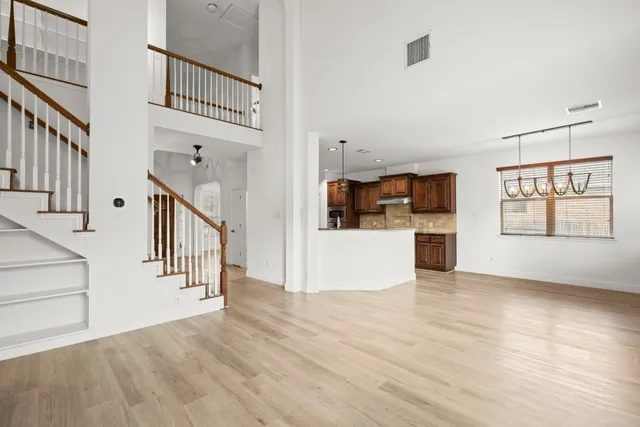 a view interior of kitchen and hall with wooden floor