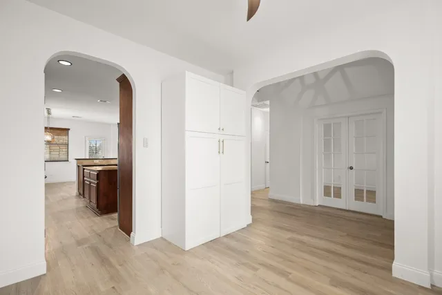 a view of a kitchen with a refrigerator and a stove top oven