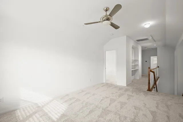 a view of a room with a ceiling fan