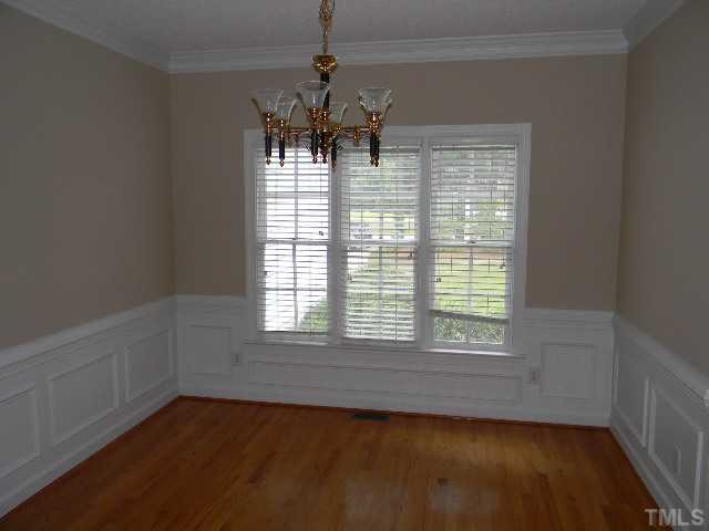 2832 Peebles Road Raleigh, NC 27616 - Photo 4 of 9 an empty room with chandelier fan and windows