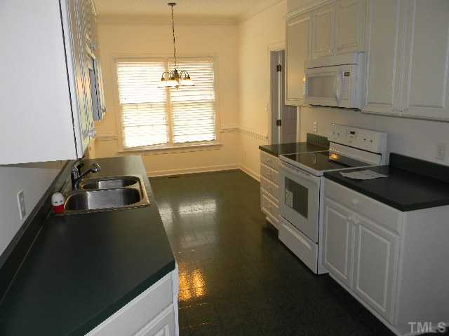 2832 Peebles Road Raleigh, NC 27616 - Photo 5 of 9 a kitchen that has a sink stove and cabinets