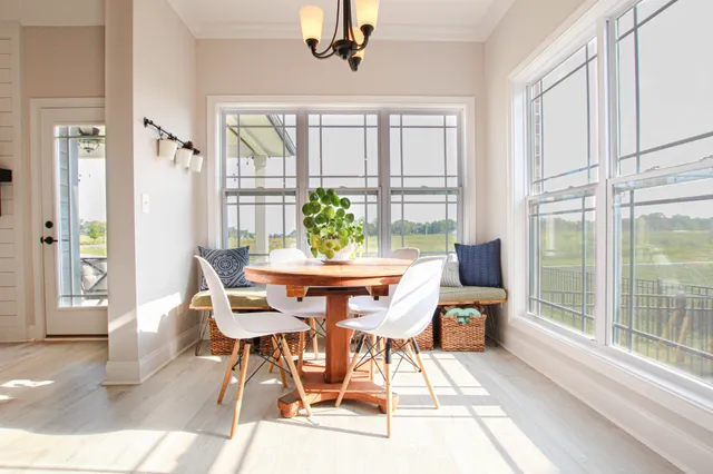 a dining room with furniture a chandelier and wooden floor