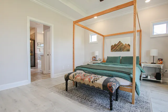 a bedroom with a bed and a painting on the wall