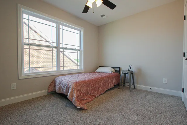 a spacious bedroom with a bed and a window