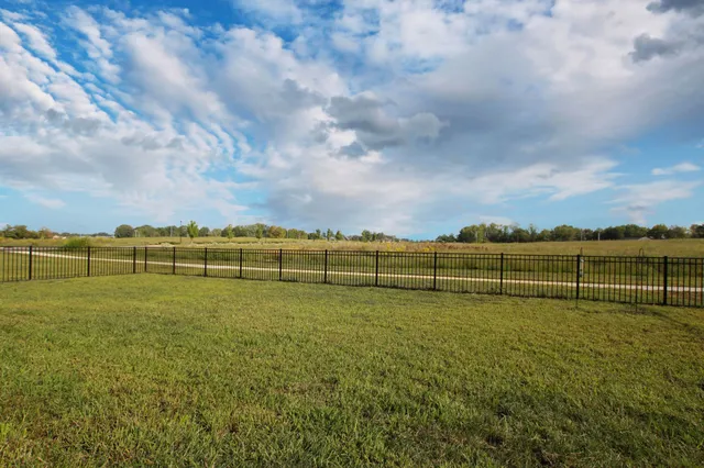 a view of a field with wooden fence