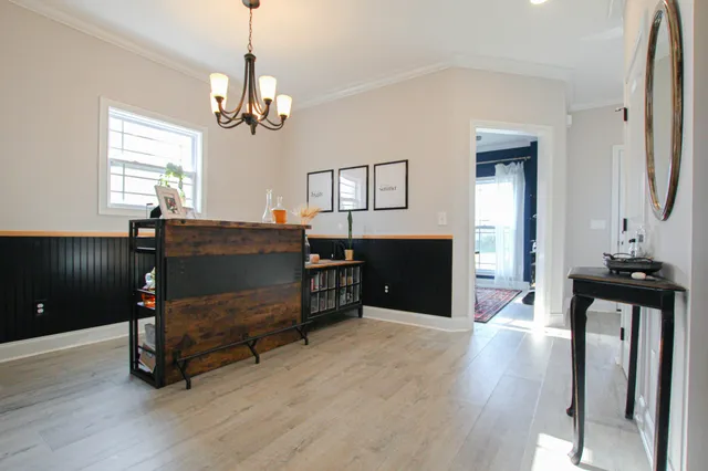 a bedroom with furniture and a chandelier