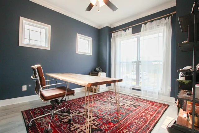 a living room with a rug furniture and a wooden floor