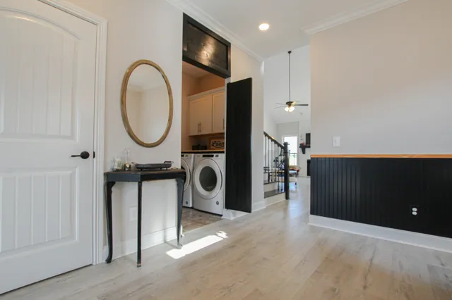 a view of a kitchen with a sink and a washer dryer