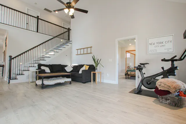 a living room with furniture and wooden floor