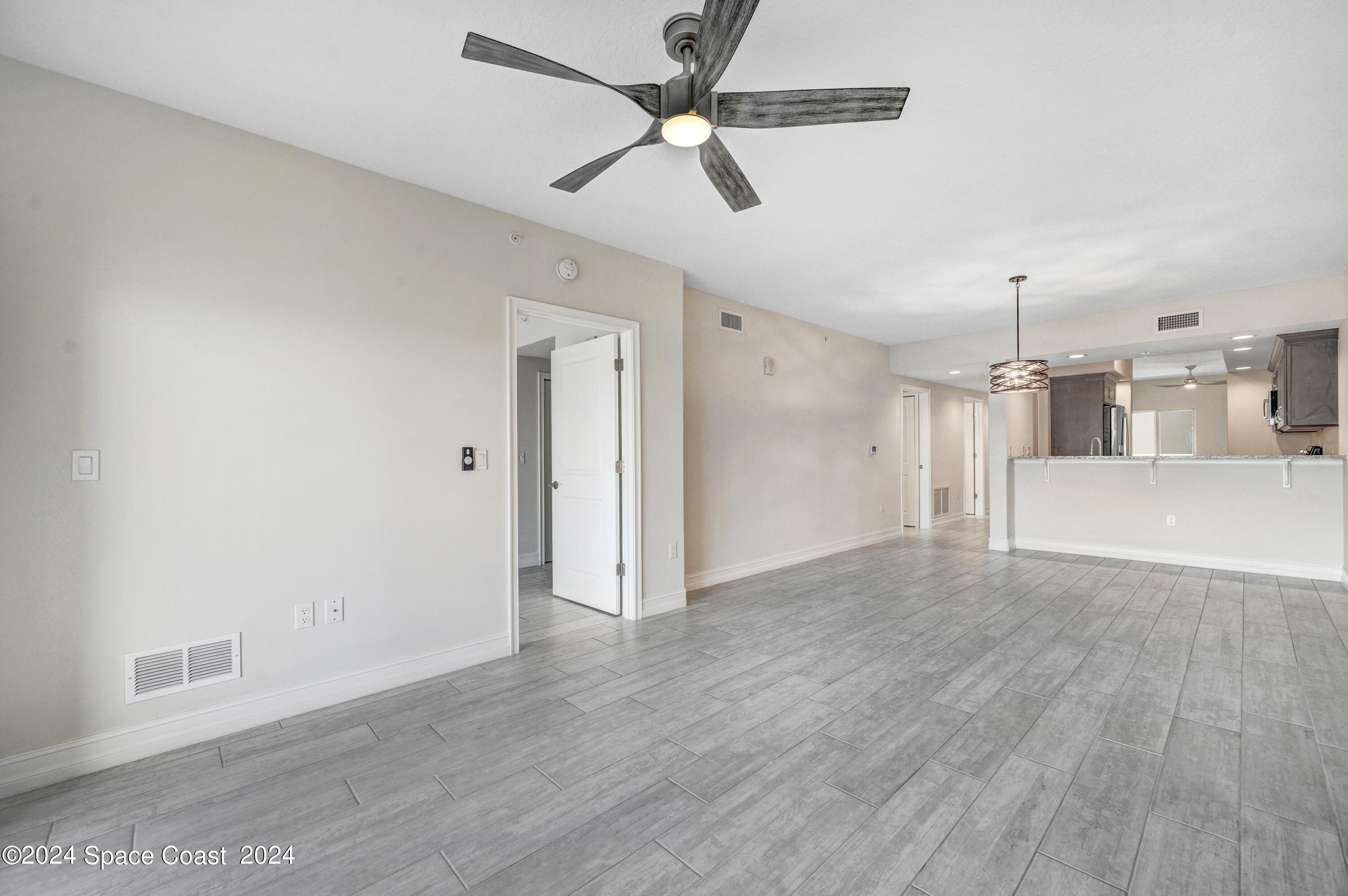 1805 Riverside Drive, Unit 606 Titusville, FL 32780 - Photo 15 of 40 a view of empty room with wooden floor and ceiling fan