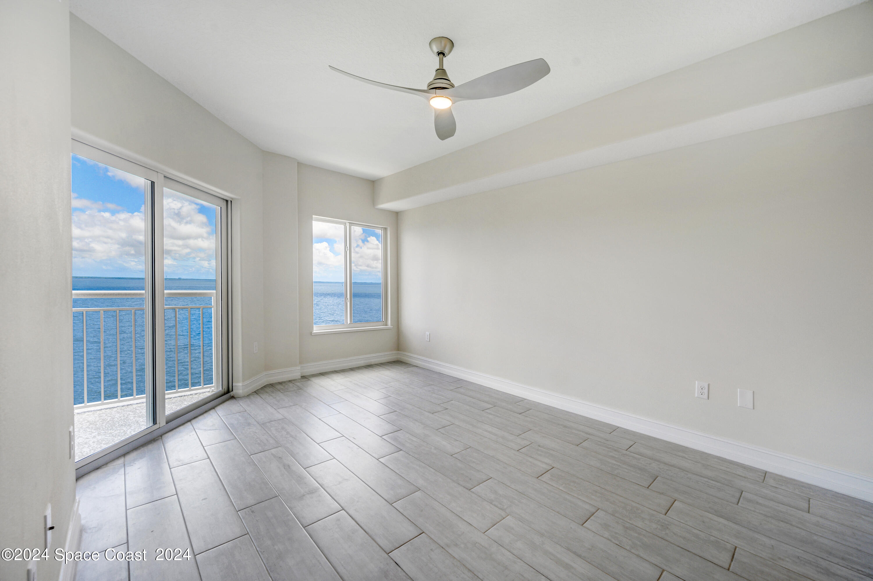 1805 Riverside Drive, Unit 606 Titusville, FL 32780 - Photo 16 of 40 wooden floor in an empty room with a window