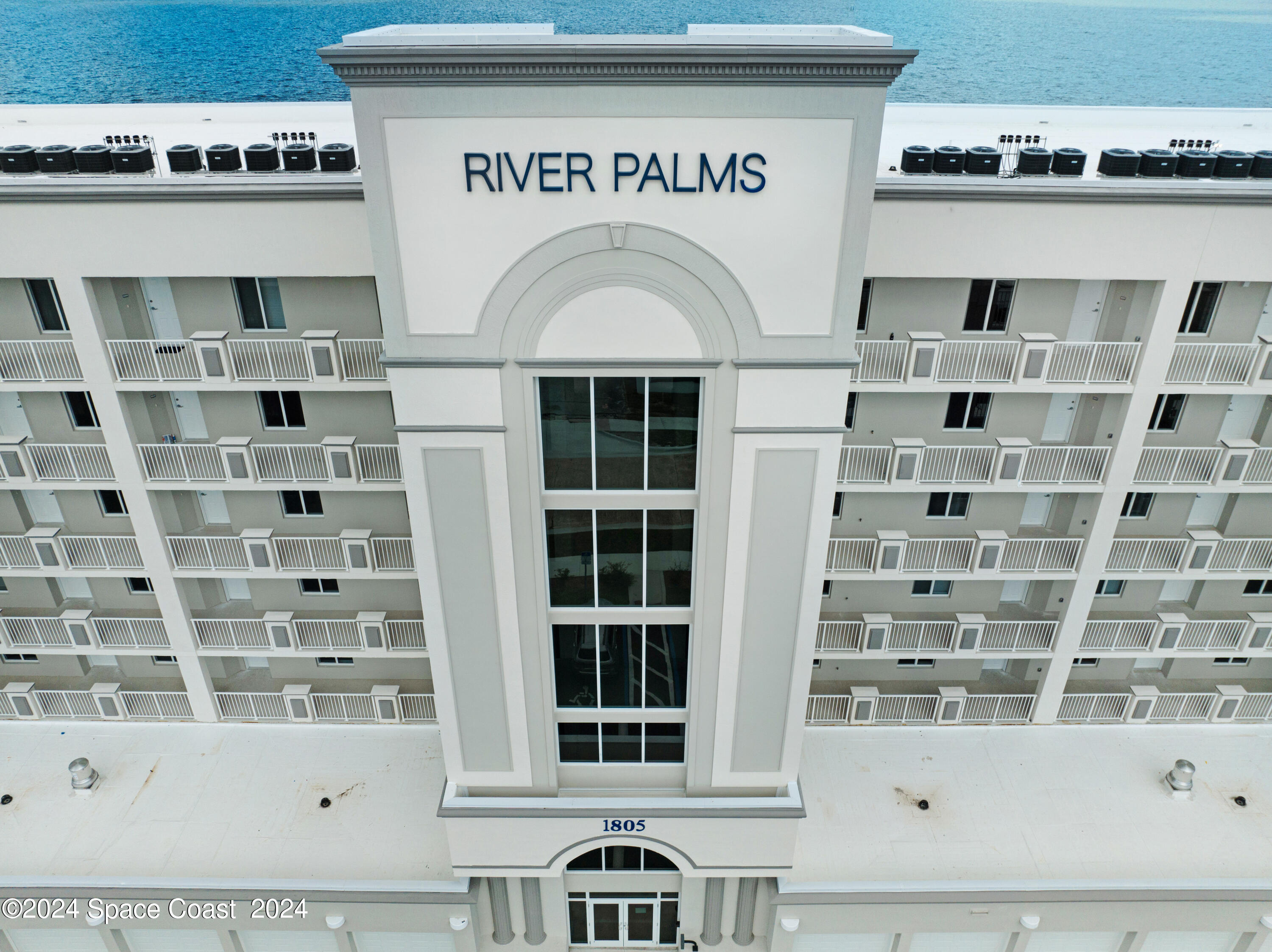 1805 Riverside Drive, Unit 606 Titusville, FL 32780 - Photo 2 of 40 a front view of a building with glass windows