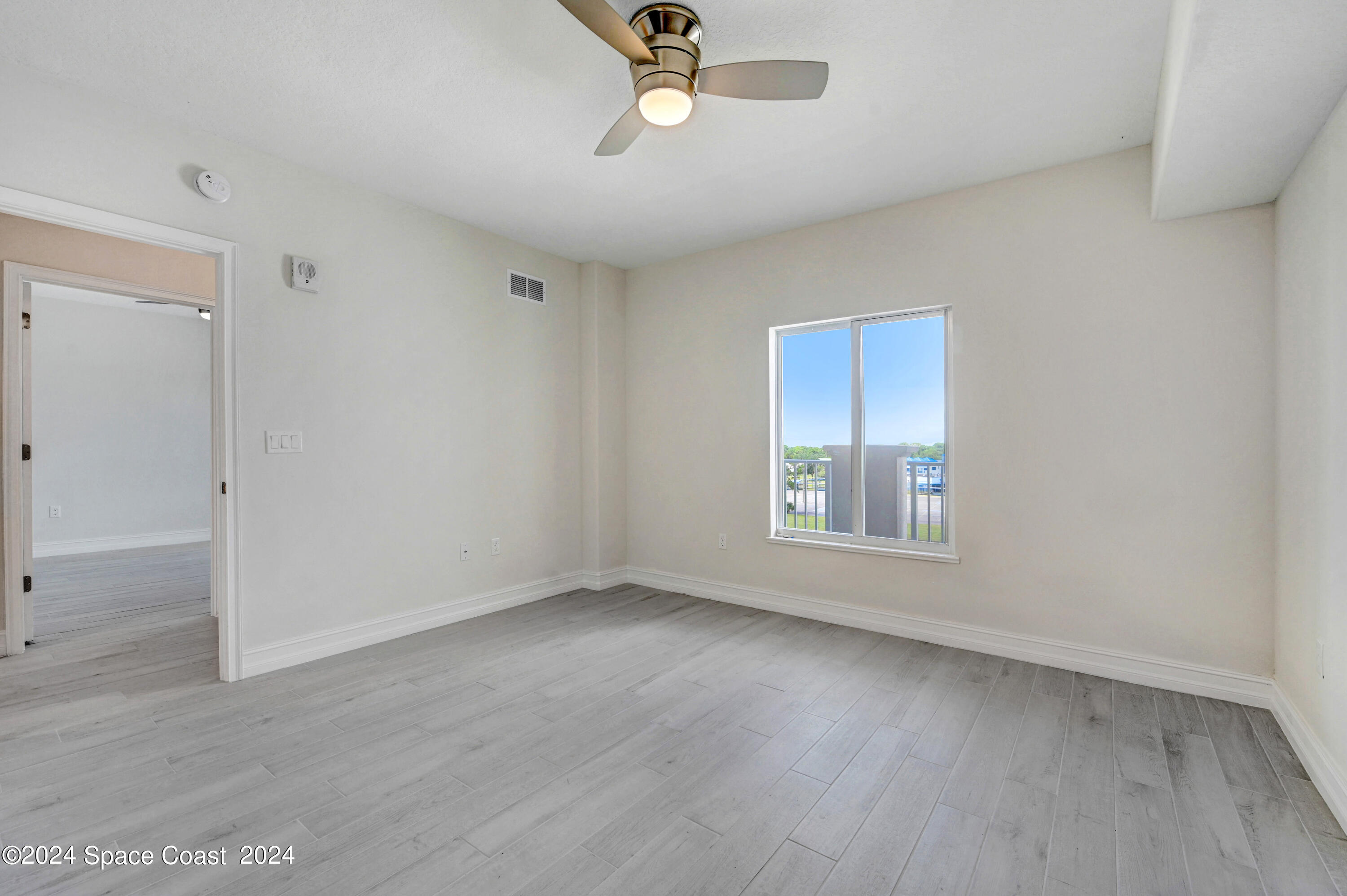 1805 Riverside Drive, Unit 606 Titusville, FL 32780 - Photo 22 of 40 wooden floor in an empty room with a window