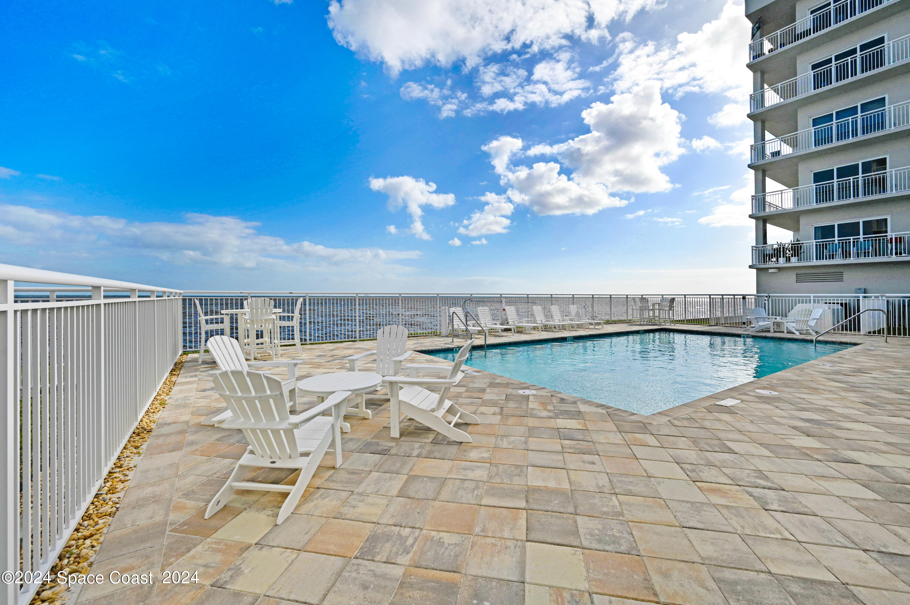 1805 Riverside Drive, Unit 606 Titusville, FL 32780 - Photo 26 of 40 a view of swimming pool with outdoor seating and yard in back