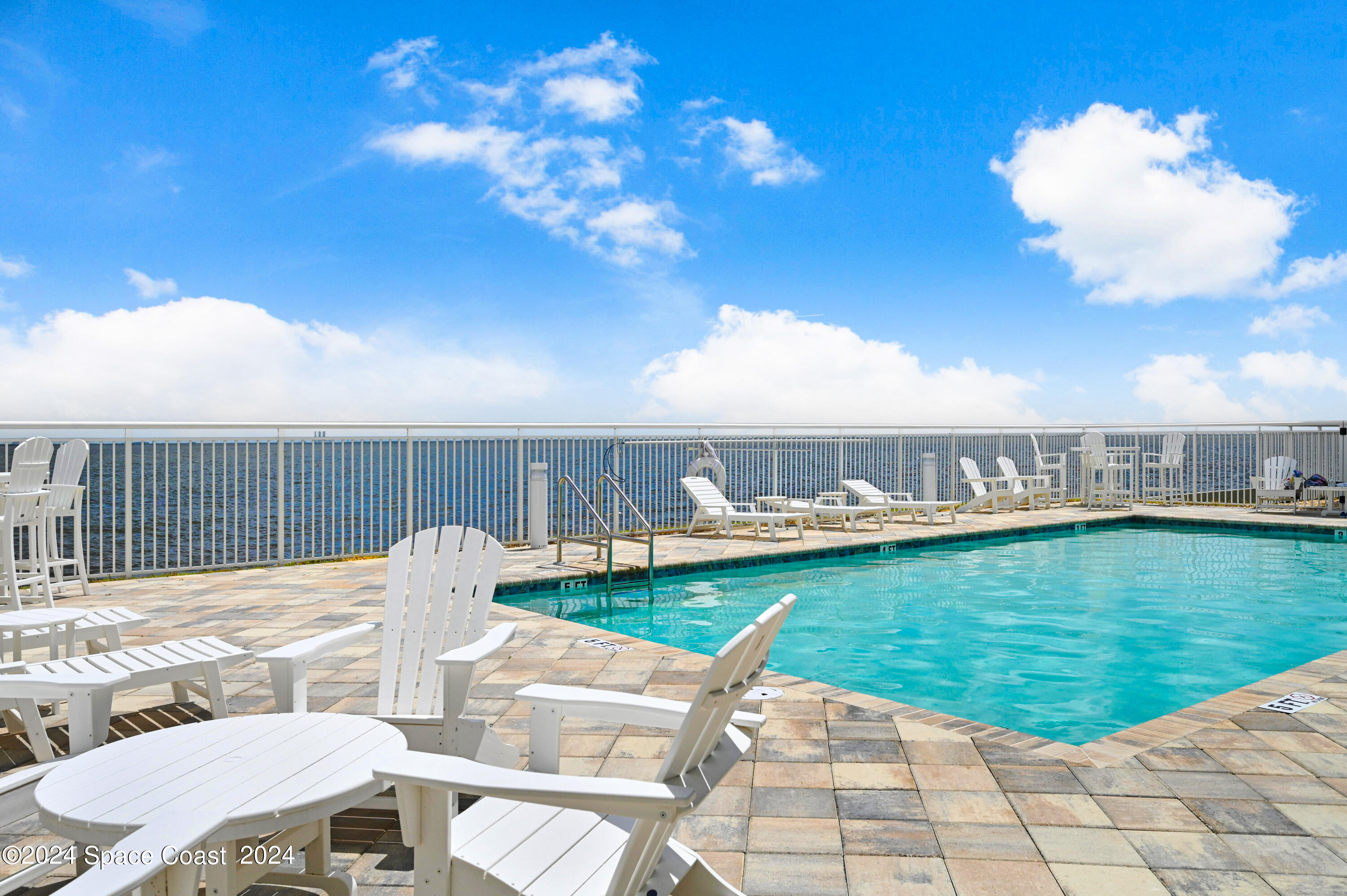 1805 Riverside Drive, Unit 606 Titusville, FL 32780 - Photo 28 of 40 a view of a swimming pool with a patio