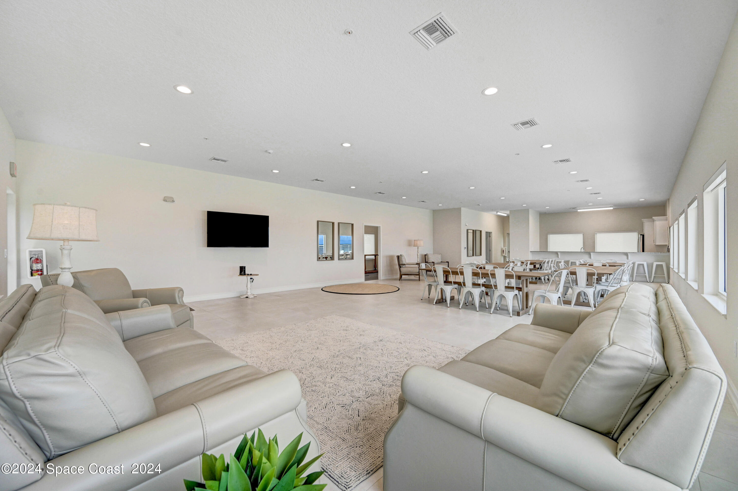 1805 Riverside Drive, Unit 606 Titusville, FL 32780 - Photo 34 of 40 a living room with furniture and a flat screen tv