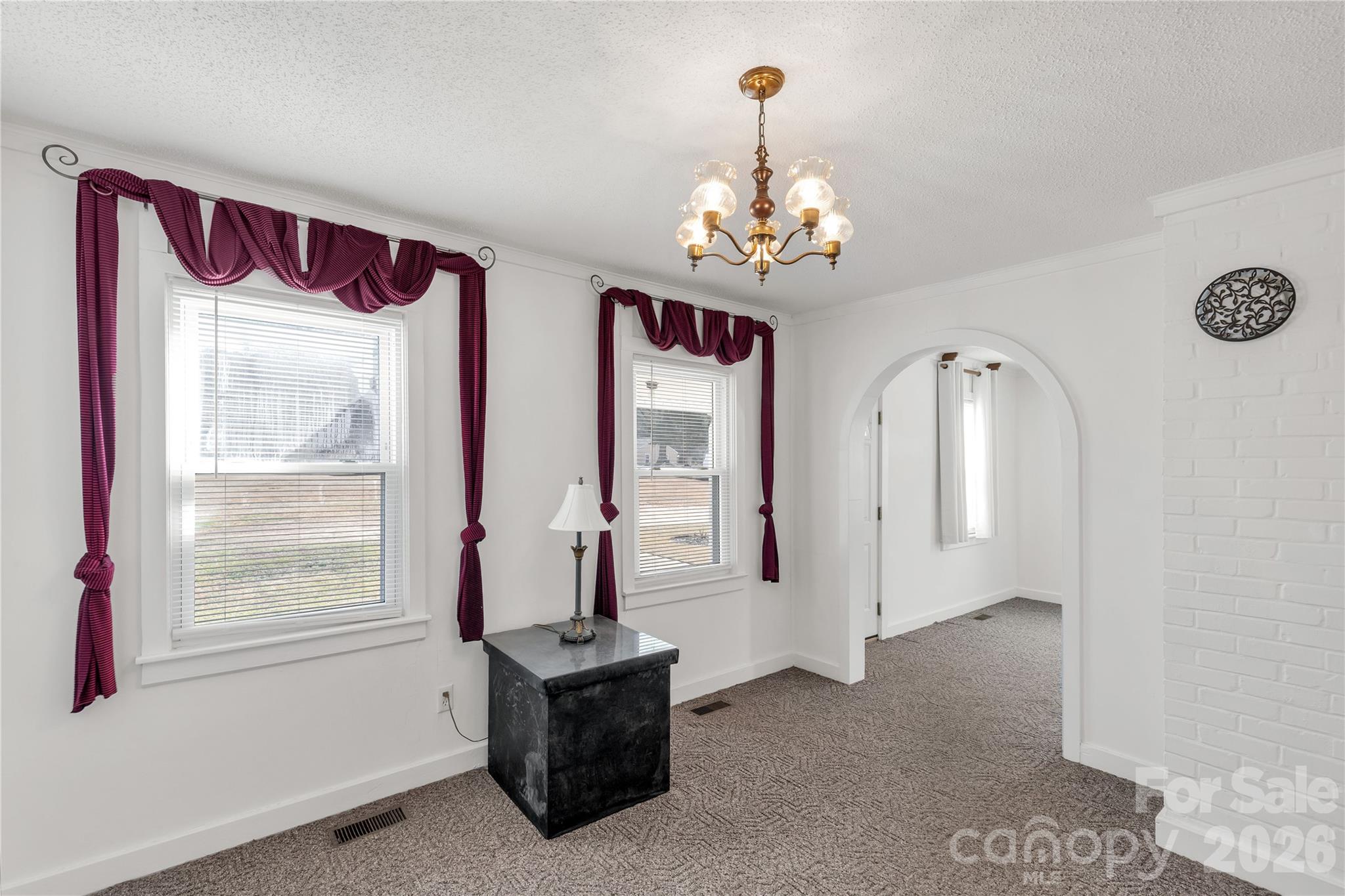 1227 Laurel Avenue Lancaster, SC 29720 - Photo 13 of 48 a view of a livingroom with wooden floor and a chandelier