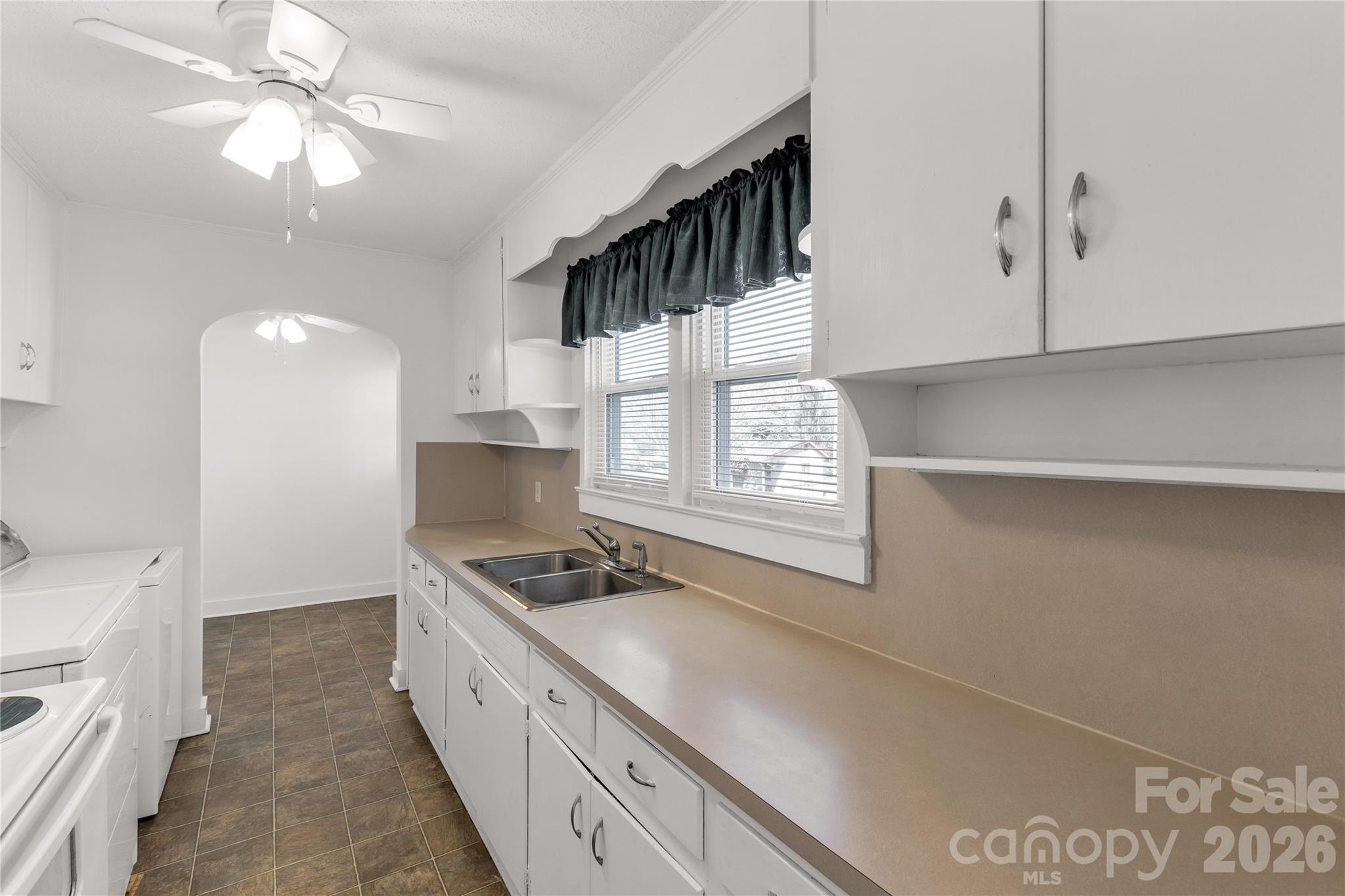 1227 Laurel Avenue Lancaster, SC 29720 - Photo 22 of 48 a kitchen with a stove a sink and a refrigerator