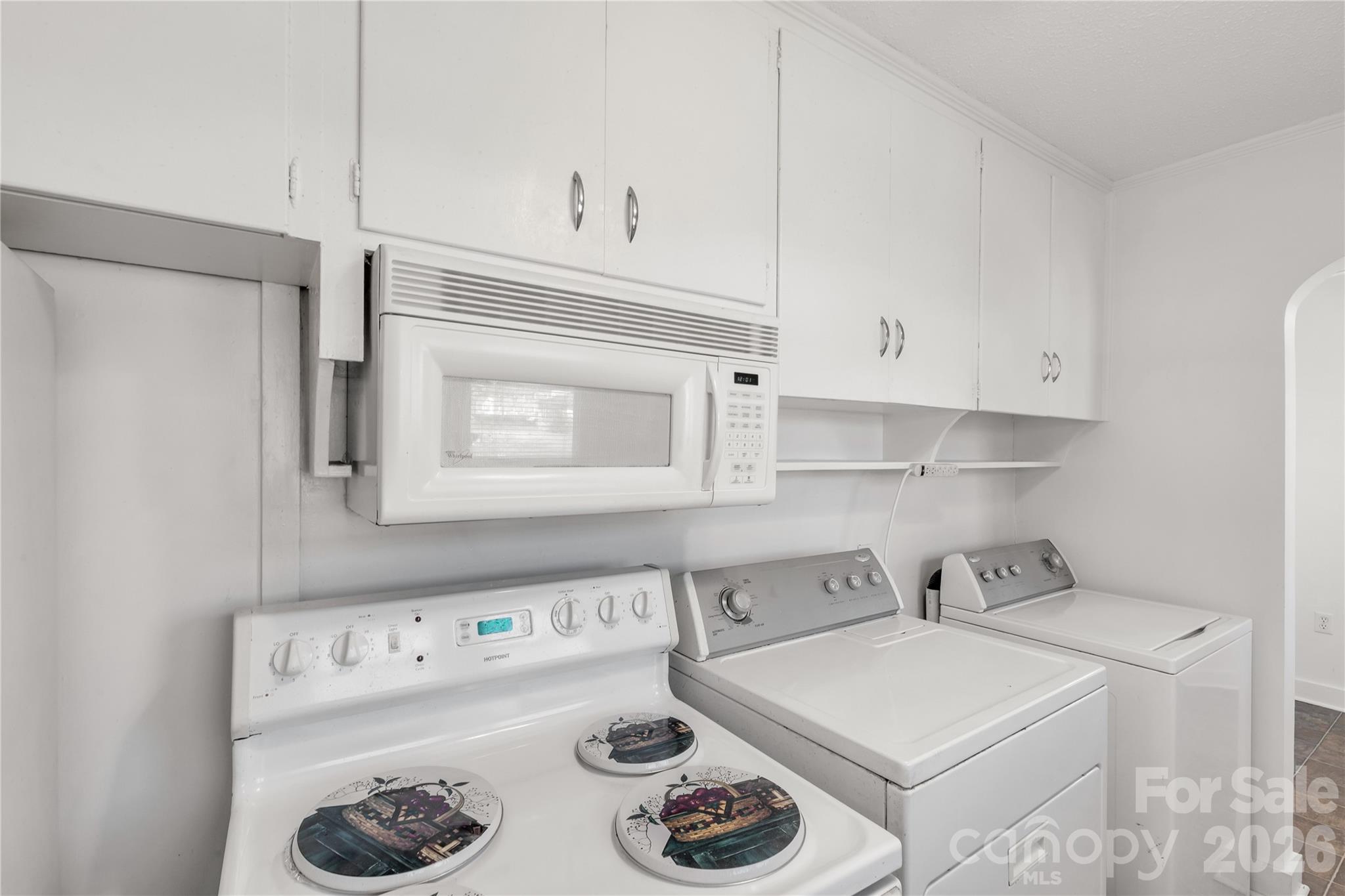 1227 Laurel Avenue Lancaster, SC 29720 - Photo 23 of 48 a kitchen with a white stove top oven and white cabinets