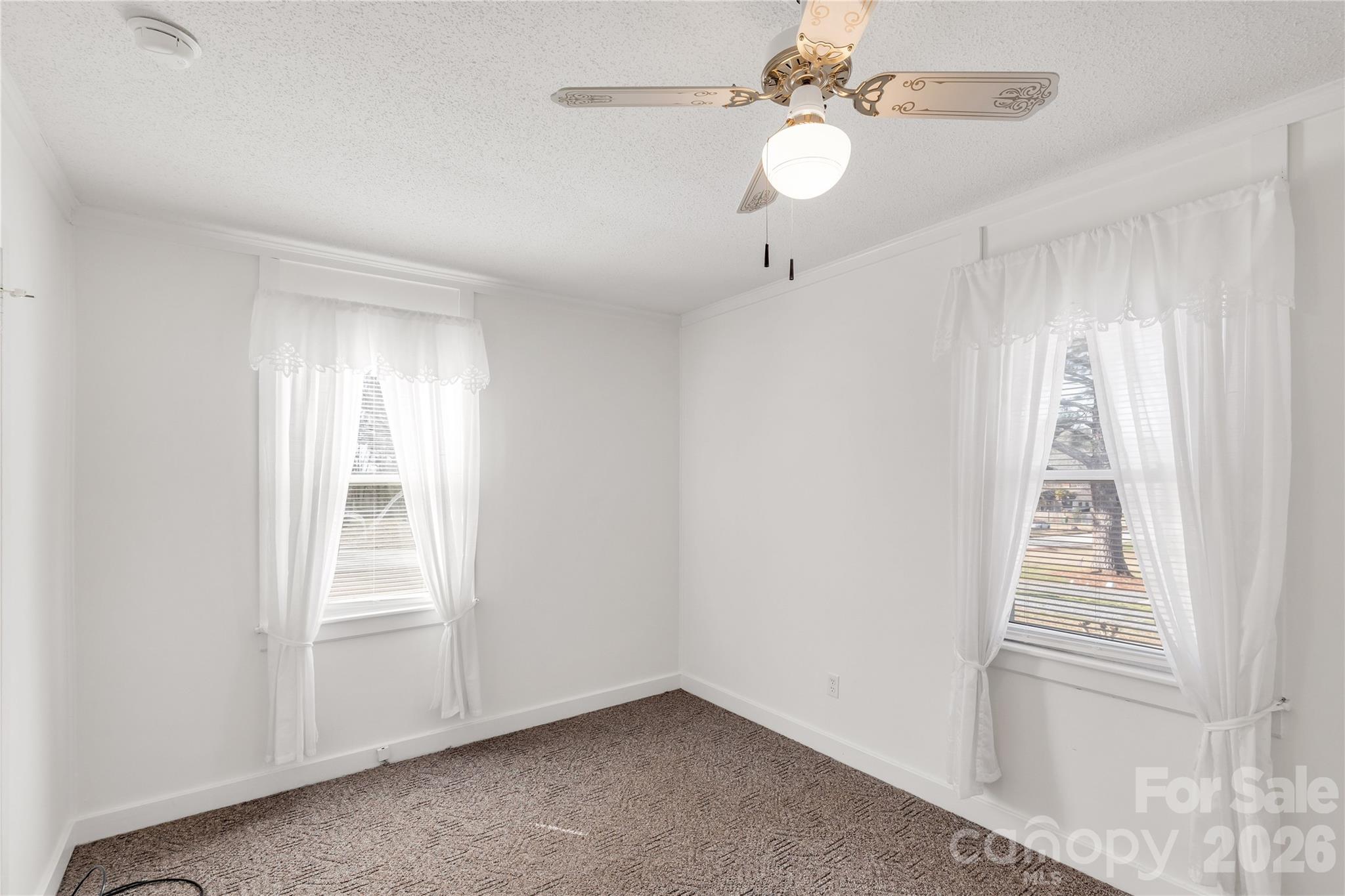 1227 Laurel Avenue Lancaster, SC 29720 - Photo 26 of 48 an empty room with windows and fan