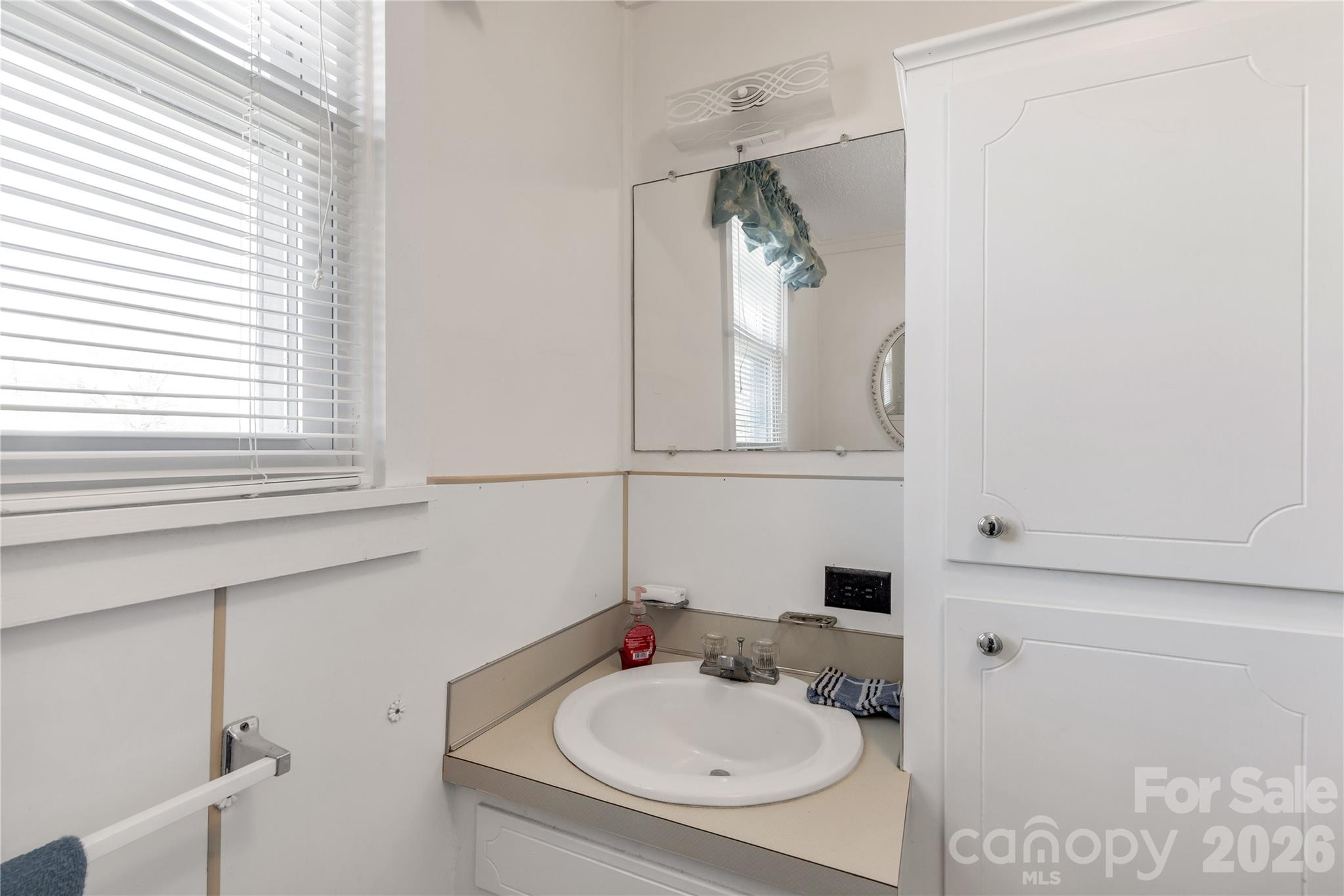 1227 Laurel Avenue Lancaster, SC 29720 - Photo 31 of 48 a bathroom with a sink and a mirror