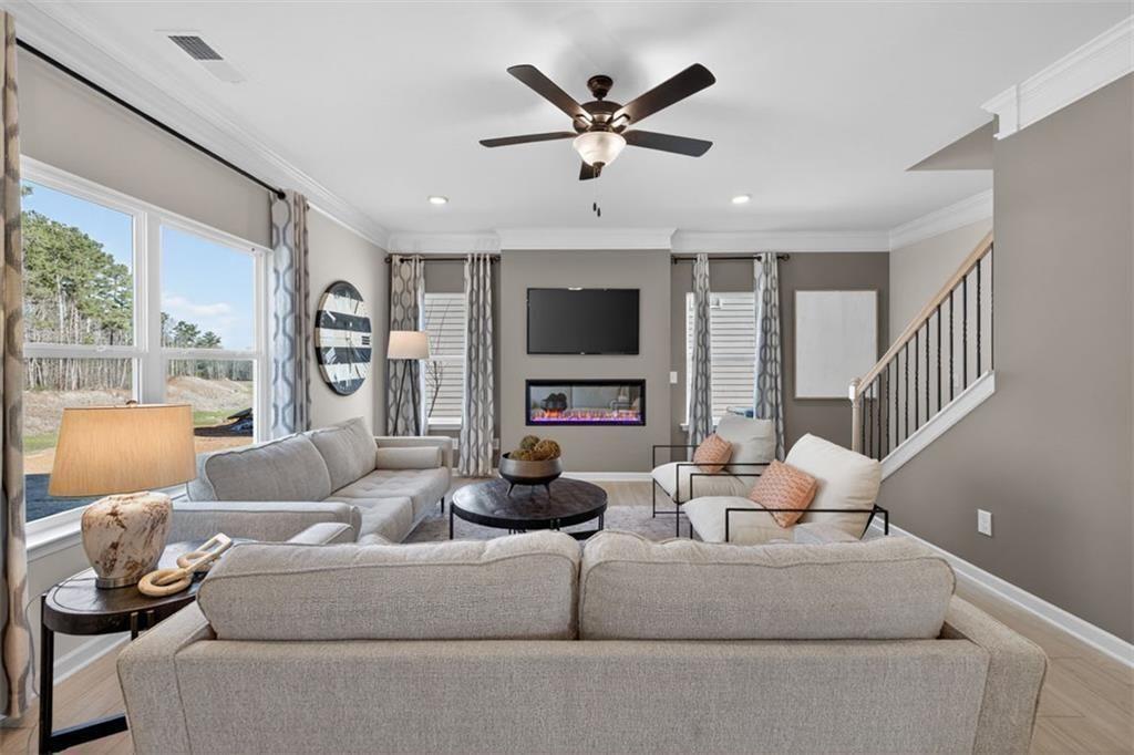 253 Shire Loop Calhoun, GA 30701 - Photo 6 of 38 a living room with furniture flat screen tv and a large window