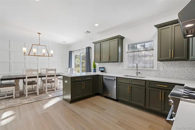a large kitchen with kitchen island granite countertop a large island in the center and stainless steel appliances