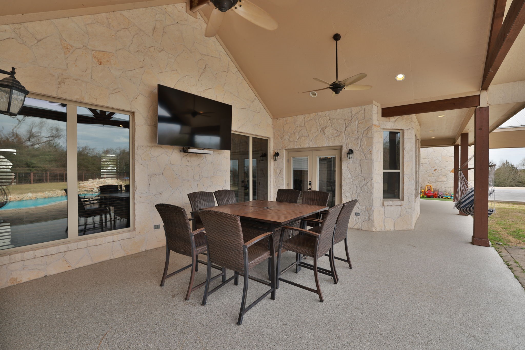 4999 Pin Oak Road Franklin, TX 77856 - Photo 39 of 47 a dining room with furniture a rug a flat screen tv and a painting