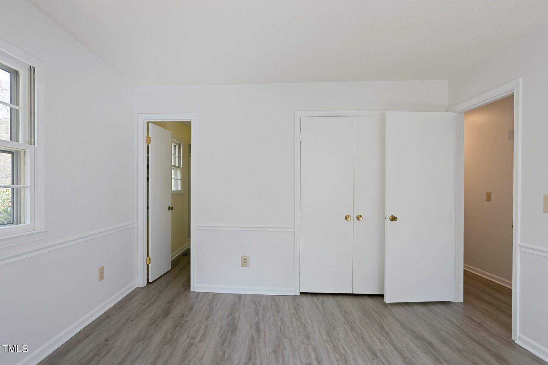 7605 Mine Valley Road Raleigh, NC 27615 - Photo 16 of 30 an empty room with wooden floor and windows