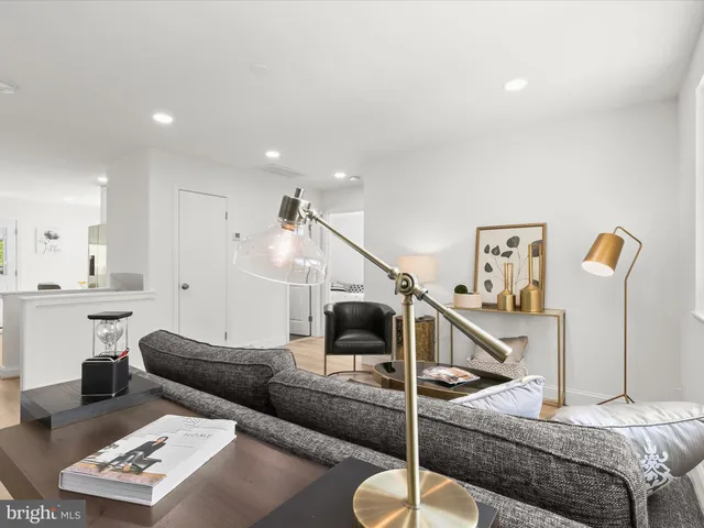 a kitchen with white cabinets appliances a sink and a window