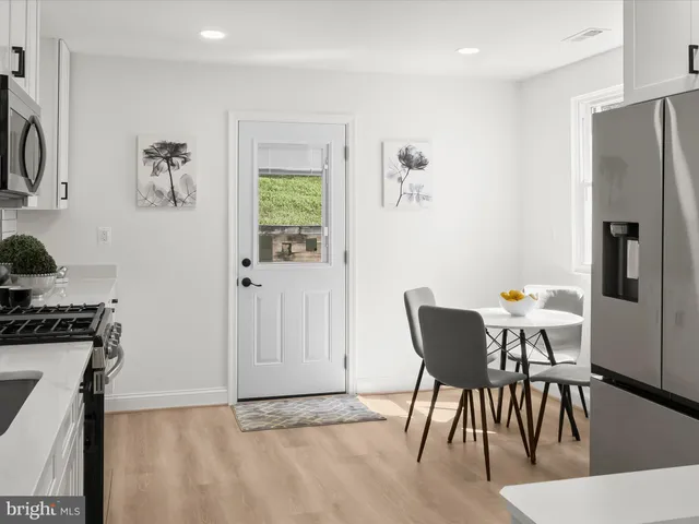 a kitchen with a stove a sink and a microwave